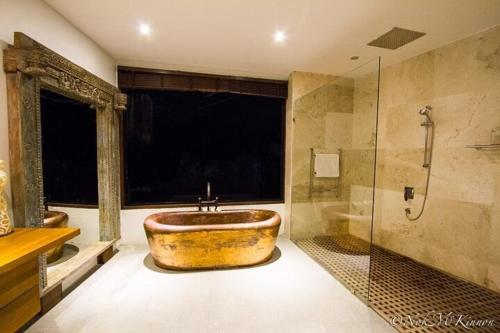 a large bathroom with a large tub and a shower at Tranquil lake view villa on Phuket golf estate in Kathu
