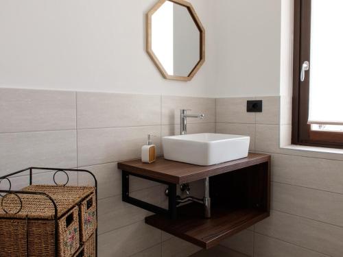 a bathroom with a white sink and a mirror at La casa di Dora in Buttigliera Alta