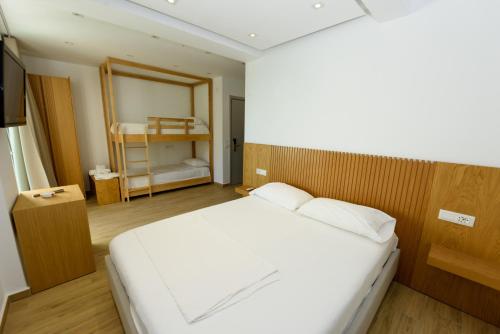a bedroom with a large white bed in a room at Hotel Nimfa in Vlorë