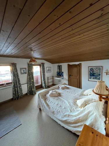 a large bed in a room with a wooden ceiling at Beautiful Family Chalet in the heart of Inneralpbach in Inneralpbach