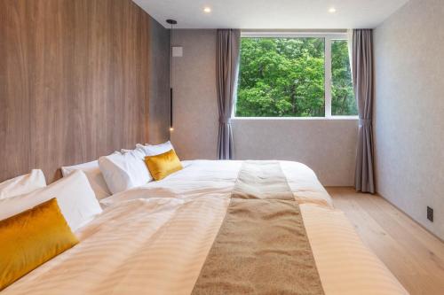 a large bed in a room with a large window at L&R RUSUTSU - Vacation STAY 05019v in Kimobetsu
