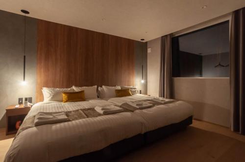 a bedroom with a large bed with a large window at L&R RUSUTSU - Vacation STAY 05019v in Kimobetsu