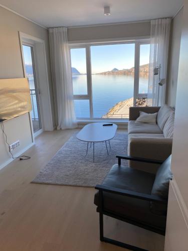 a living room with a couch and a table at Ny leilighet i Ålesund med fantastisk utsikt in Ålesund
