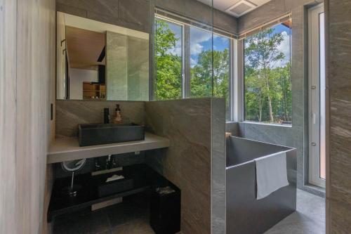 a bathroom with a sink and a mirror at L&R RUSUTSU - Vacation STAY 05019v in Kimobetsu