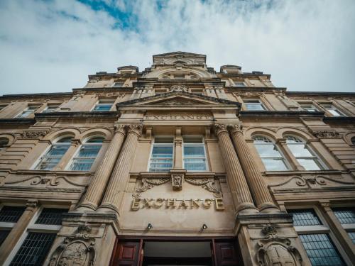 a tall building with the words exchange on it at The Coal Exchange Hotel in Cardiff