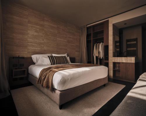 a bedroom with a large bed in a room at Casa Cook Madonna - Adults Only in Madonna di Campiglio