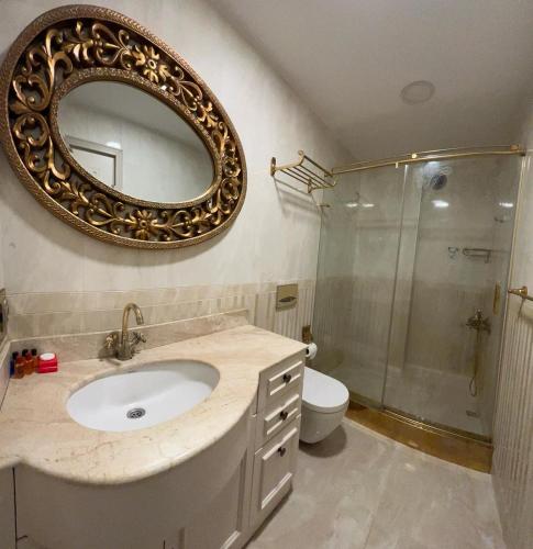 a bathroom with a sink and a mirror on the wall at Le Marde Hotel in Istanbul