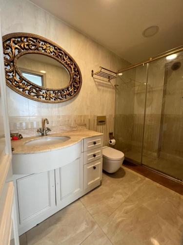 a bathroom with a sink and a mirror and a toilet at Le Marde Hotel in Istanbul
