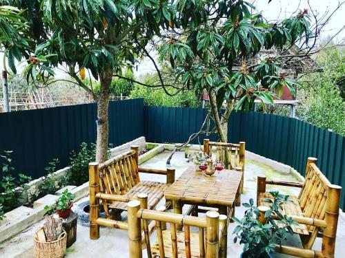 a patio with a wooden table and two chairs at Home Inn Samegrelo in Kheta