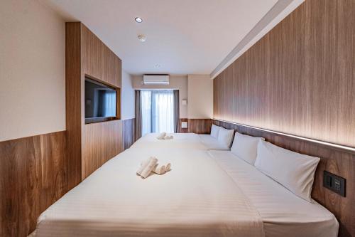 Postel nebo postele na pokoji v ubytování Apartment Hotel 11 Kuromon 5