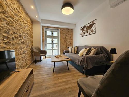 a living room with a couch and a table at Silk Suites by YHA in Athens