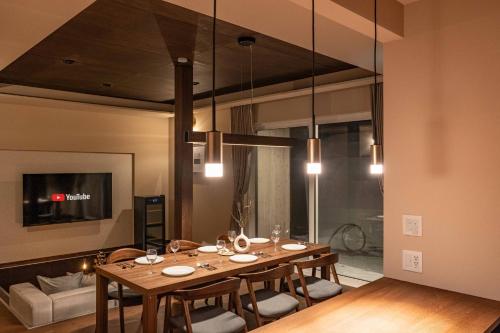 a dining room with a table and a couch at L&R RUSUTSU - Vacation STAY 67508v in Kimobetsu