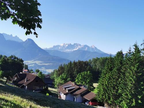a group of houses on a hill with mountains in the background at Apartment Schmetterling in Collalbo
