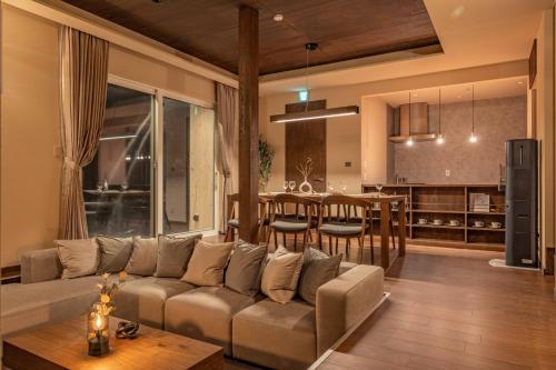 a living room and kitchen with a couch and a table at L&R RUSUTSU - Vacation STAY 67508v in Kimobetsu