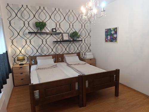 a bedroom with a bed and a chandelier at Apartman Tarik in Sarajevo