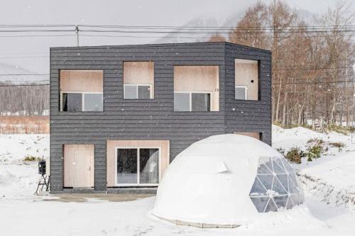 a house in the snow with a igloo in front at L&R RUSUTSU - Vacation STAY 67508v in Kimobetsu