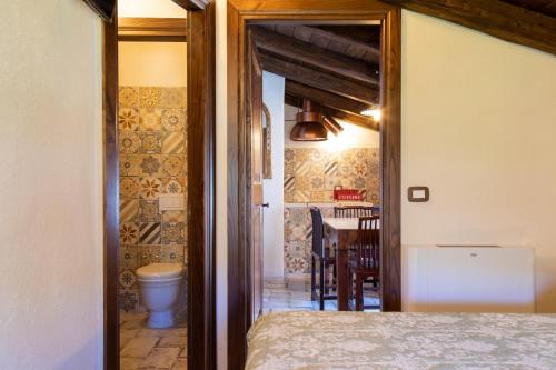 a bedroom with a bed and a dining room with a table at Festina Lente - Guest House in Santo Stefano di Sessanio