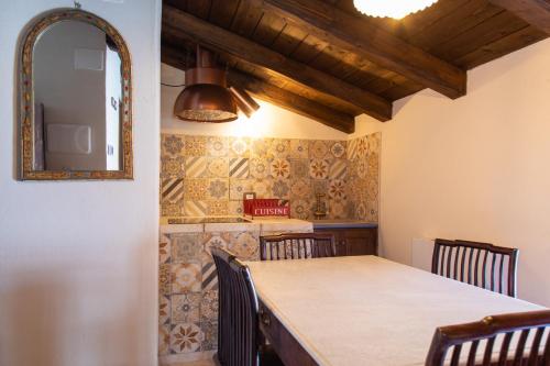 a dining room with a table and a mirror at Festina Lente - Guest House in Santo Stefano di Sessanio