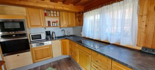 a kitchen with wooden cabinets and a counter top at Landruhe in Gimplach