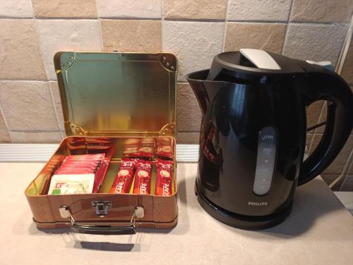 a coffee pot and a suitcase on a counter next to a mug at Apartman Tarik in Sarajevo