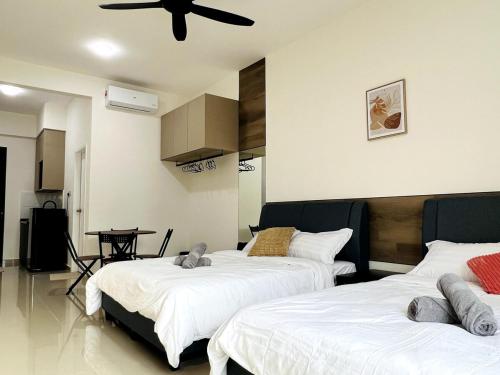 a bedroom with two beds and a ceiling fan at Studio 2bed4pax KekLokSi View in Ayer Itam