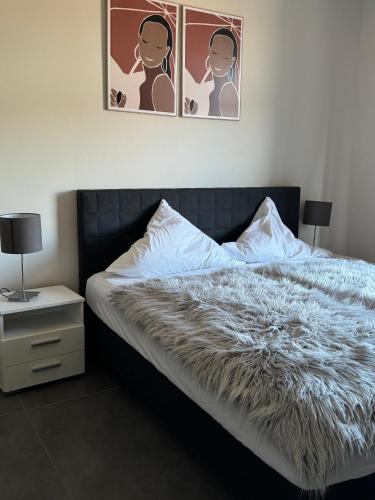 a bedroom with a bed with a faux fur blanket at Pier 1 bis 4 gmütliche Zimmer mit Boxspringbett in Cuxhaven