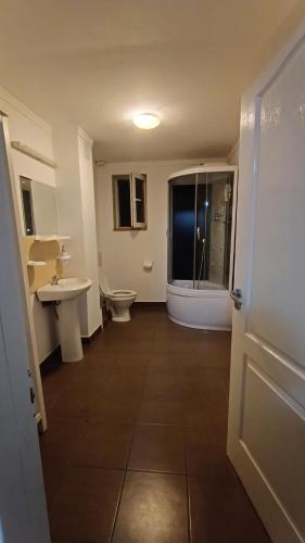a bathroom with a toilet and a sink and a shower at Casa Rosa in Piatra Neamţ