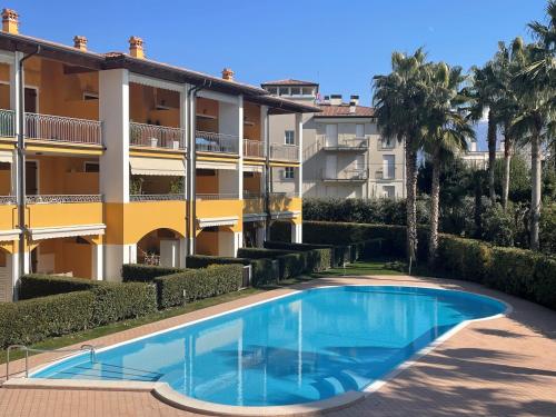 an apartment with a swimming pool in front of a building at Casa Santi Il silenzio tra lago e montagna in Toscolano Maderno
