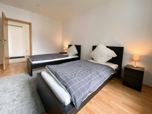a bedroom with two beds and a mirror at City Appartement in Gelsenkirchen