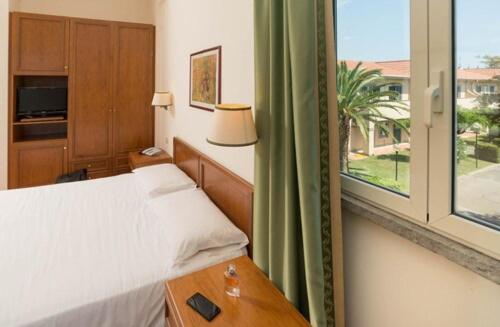 Postel nebo postele na pokoji v ubytování Hotel Baia Del Sole