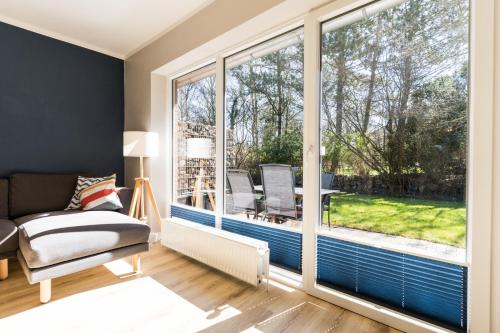 ein Wohnzimmer mit großem Fenster und einer Couch in der Unterkunft Am Hof 3 in Staberdorf