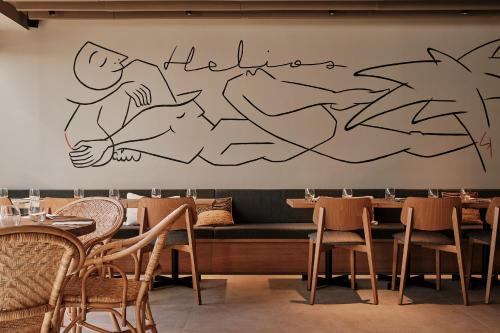 a restaurant with a mural of a person on the wall at Helios Mallorca Hotel & Apartments in Can Pastilla