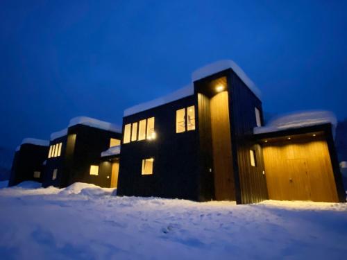 a group of buildings in the snow at night at L&R RUSUTSU - Vacation STAY 05027v in Kimobetsu