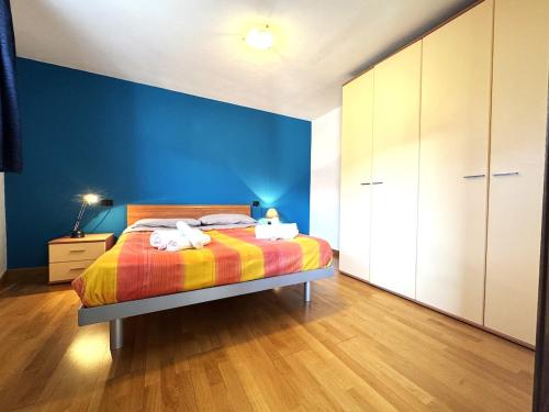 a bedroom with a bed and a blue wall at Borgo antico con terrazzo panoramico - Bluchalet in Aosta