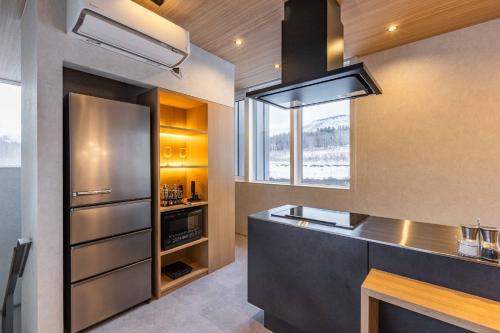 a kitchen with a stainless steel refrigerator and a window at L&R RUSUTSU - Vacation STAY 05027v in Kimobetsu