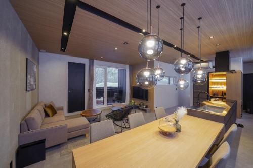 a kitchen and living room with a table and a couch at L&R RUSUTSU - Vacation STAY 05027v in Kimobetsu