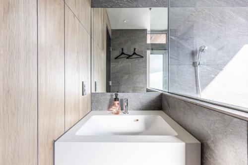 a bathroom with a white sink and a shower at L&R RUSUTSU - Vacation STAY 05027v in Kimobetsu