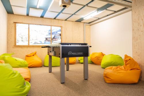 a room with yellow and orange bean bags at Montela Apartment-Hotel & Resort in the holiday region Saas-Fee Saastal in Saas-Grund