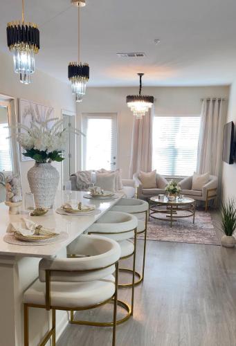 a white living room with a table and chairs at Atlanta Beltline Luxury Double Suite in Atlanta