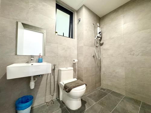a bathroom with a toilet and a sink and a shower at Sunsuria Forum SOHO & Residence Suites Setia Alam by MOKA in Shah Alam