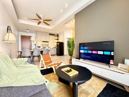 a living room with a large flat screen tv at Sunsuria Forum SOHO & Residence Suites Setia Alam by MOKA in Shah Alam