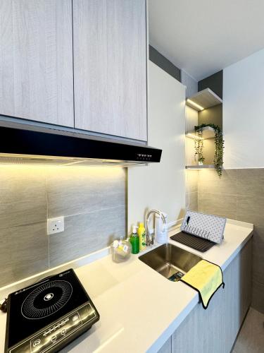 a kitchen with a sink and a counter top at Sunsuria Forum SOHO & Residence Suites Setia Alam by MOKA in Shah Alam
