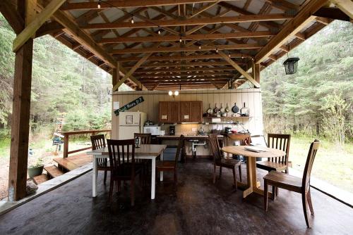 a kitchen and dining room with a table and chairs at Alaskan Yurt Glamping, Perfect for a Couples Getaway in Seward