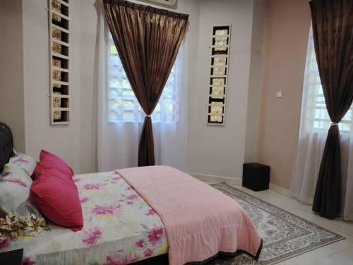 a bedroom with a bed and two windows with curtains at Wanda Homestay Terengganu in Kampong Wakaf Tengah