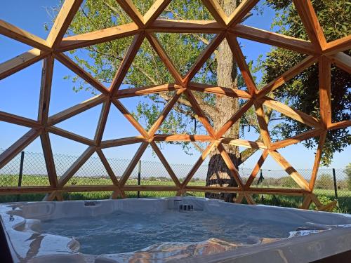 a view from the inside of a wooden roof with a hot tub at Gîte de charme et spa prés d'Albi , Au Mas de Bel Air in Arthès