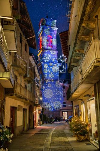a tall tower with christmas lights on a street at San Rocco in Giaveno