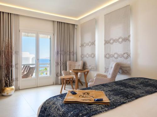 a bedroom with a bed and a view of the ocean at Anax Resort and Spa in Agios Ioannis Mykonos