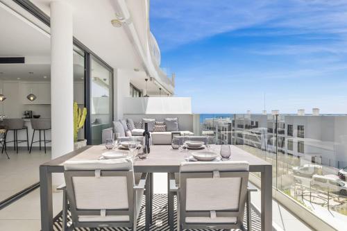 a dining room with a table and chairs on a balcony at ViVi Homes - Casa Española in Fuengirola