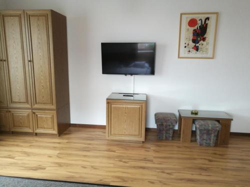 a living room with a flat screen tv on a wall at Gründner Vendégház in Siófok