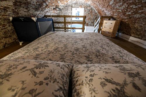a bedroom with a bed in a brick wall at RUSTICO ALLE MURA Love & Bike in Toirano
